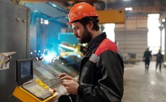 side-view-of-young-engineer-in-workwear-using-digital-tablet